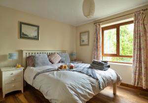 a bedroom with a bed and a window at Finest Retreats - The Dairyhouse in Church Stoke