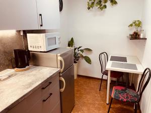 a small kitchen with a small table and a microwave at Apartament Gryf in Gryfów Śląski