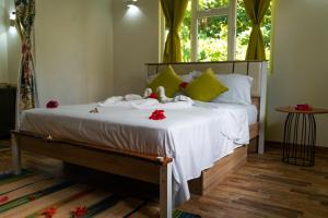 a bedroom with a bed with stuffed animals on it at Villa Charette-Self Catering Villas in La Digue
