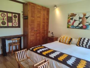 מיטה או מיטות בחדר ב-Casa Campestre con piscina compartida