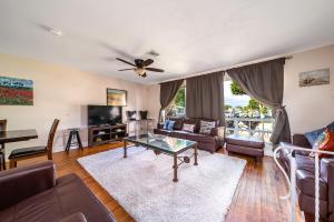 a living room with a couch and a table at Pool Home in Hollywood