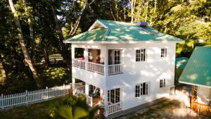 an aerial view of a white house with a green roof at Villa Charette-Self Catering Villas in La Digue