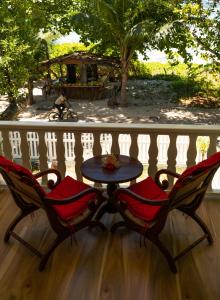 a table and two chairs on a porch at Villa Charette-Self Catering Villas in La Digue