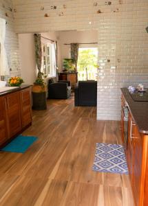 a kitchen and living room with a hard wood floor at Villa Charette-Self Catering Villas in La Digue +11 photos
