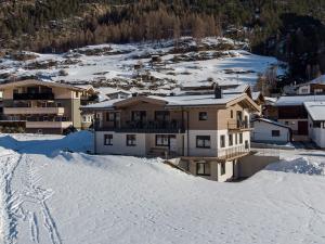 a house on top of a snow covered mountain at Landhaus Sonnenwiese in Sölden