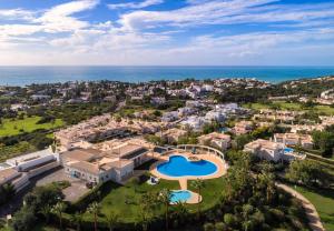 an aerial view of a resort with a swimming pool and the ocean at Casa Atlantida Golfemar in Carvoeiro