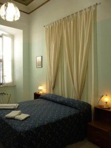 a bedroom with a bed with two towels on it at Hotel Ferraro in Rome