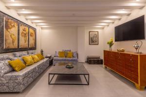 a living room with a couch and a tv at Mexico Historic Center Modern Apartment in Mexico City