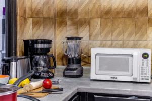 a kitchen counter with a blender and a microwave at Mexico Historic Center Modern Apartment in Mexico City +35 photos