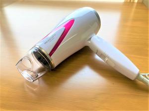 a electric hair dryer sitting on a wooden table at Hotel PEACE PARK Tokaichi - Vacation STAY 95327v in Hiroshima