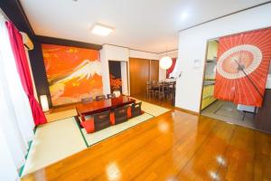 a living room with a large painting on the wall at Inoue Building - Vacation STAY 95362v in Tokyo