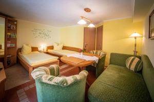 a living room with a table and chairs and a room at Ferienwohnung-Kopprasch in Dresden