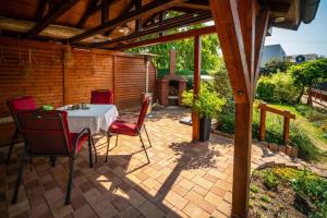 a patio with a table and chairs and a fireplace at Ferienwohnung-Kopprasch in Dresden