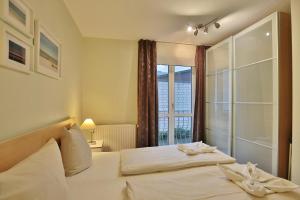 Postel nebo postele na pokoji v ubytování Gorch-Fock-Straße 16 Gorch-Fock-Str 16 Appartement 1