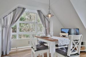 a dining room with a table and a window at Im Brook 36-38 Am Elchgrund Appartement 12 in Timmendorfer Strand