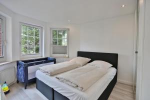Postel nebo postele na pokoji v ubytování Ferienhaus Glockenstraße Ferienwohnung Ostseehöhe Appartement 1