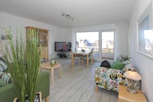 a living room with a couch and a table at Haus an der Strandallee 112 Haus an der Strandallee 112 Appartement 7 in Scharbeutz