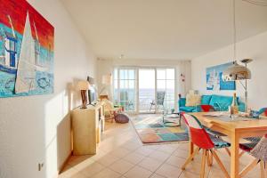 a living room with a table and a dining room at Stranddomizil Stranddomizil Appartement 14 in Haffkrug