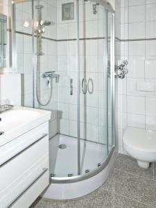 a bathroom with a shower and a sink and a toilet at Residenz Ostseestrand Appartement 23 in Scharbeutz