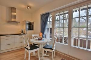 a kitchen with a table and chairs and a window at Seepark Seepark Appartement 2 in Scharbeutz