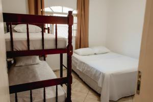 アングラ・ドス・レイスにあるMoni & Junior Hospedagemのベッドルーム1室(二段ベッド2台、窓付)が備わります。