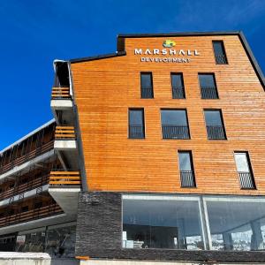 a building with a sign on the side of it at Marshal Gudauri in Gudauri