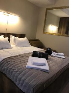 a hotel room with a bed with towels on it at Marshal Gudauri in Gudauri