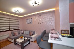 a living room with a couch and a table at Sunset Lux S3 Wellness & Spa Zlatibor in Zlatibor