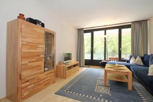 a living room with a blue couch and a large window at Strandresidenz Timmendorfer Strand Strandresidenz Appartement 203 in Timmendorfer Strand