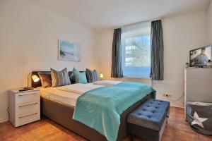 Postel nebo postele na pokoji v ubytování Gorch-Fock-Straße 34 Gorch-Fock-Str 34 Appartement 1