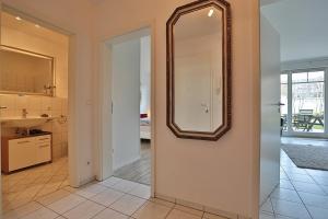 La salle de bains est pourvue d'un miroir et d'un lavabo. dans l'établissement Haus Strandstrasse Strandstrasse 150 Appartement 2, à Niendorf