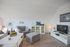 TV a/nebo společenská místnost v ubytování Doppelhaushälfte Am Knurrhahn Am Knurrhahn Appartement 2