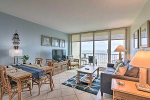 a living room with a couch and a table at Heated Pool and Beach View Galveston Resort Condo! in Galveston