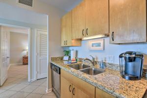 a kitchen with a sink and a counter top at Heated Pool and Beach View Galveston Resort Condo! in Galveston