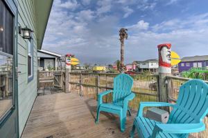 two blue chairs sitting on the deck of a house at Walk to Shore: Cottage w/ Deck in Surfside Beach! in Freeport