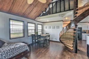 a bedroom with a staircase leading to a dining room at Walk to Shore: Cottage w/ Deck in Surfside Beach! in Freeport
