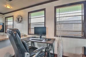 an office with a desk with a computer and two windows at Walk to Shore: Cottage w/ Deck in Surfside Beach! in Freeport