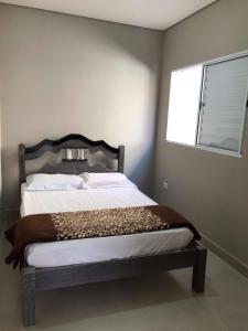 Tempat tidur dalam kamar di Quiosque 2