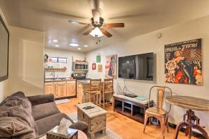 a living room with a couch and a ceiling fan at Hike, Shop and Unwind Tucson Home with Shared Hot Tub in Tucson +28 photos