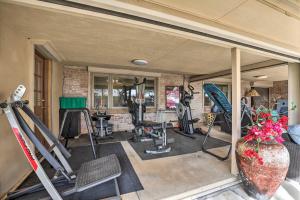 a gym with several exercise equipment in a room at Hike, Shop and Unwind Tucson Home with Shared Hot Tub in Tucson
