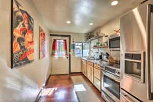 a kitchen with stainless steel appliances and wooden cabinets at Tucson Casita with Courtyard, Hot Tub and Fire Pits! in Tucson