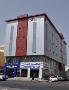 a man walking in front of a building at منازل بجيلة للاجنحة الفندقية Manazel Begela Hotel Apartments in Taif