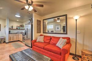 a living room with a red couch and a kitchen at Pet-Friendly Tucson Casita Shared Hot Tub and Porch in Tucson