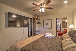 a bed in a living room with a ceiling fan at Pet-Friendly Tucson Casita Shared Hot Tub and Porch in Tucson