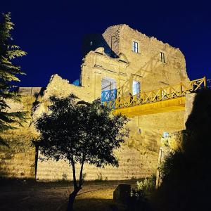 a tree in front of a building with a bridge at Residenza Matilde in Fiumefreddo Bruzio