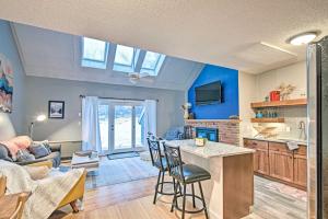 a kitchen and living room with a table and chairs at Ski-InandSki-Out Tenney Mountain Resort Getaway in Plymouth