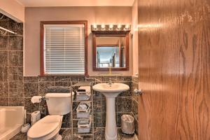 a bathroom with a sink and a toilet and a mirror at Pet-Friendly Retreat with Deck Steps to Marina! in Wabasha