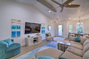a living room with a couch and a table at Chic Cocoa Beach Oasis with Pool - Steps to Shore! in Cocoa Beach