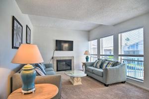 a living room with a couch and a fireplace at Coastal Madeira Beach Condo - Walk to Gulf! in St. Pete Beach