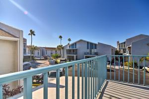 a balcony of a unit with palm trees and houses at Coastal Madeira Beach Condo - Walk to Gulf! in St. Pete Beach